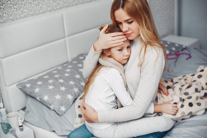 Mother with her illnes daughter in a bedroom
